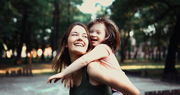 Little girl with special needs enjoy spending time with mother in nature